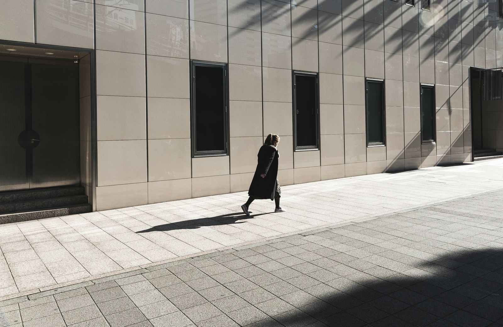 A person walking past business premises